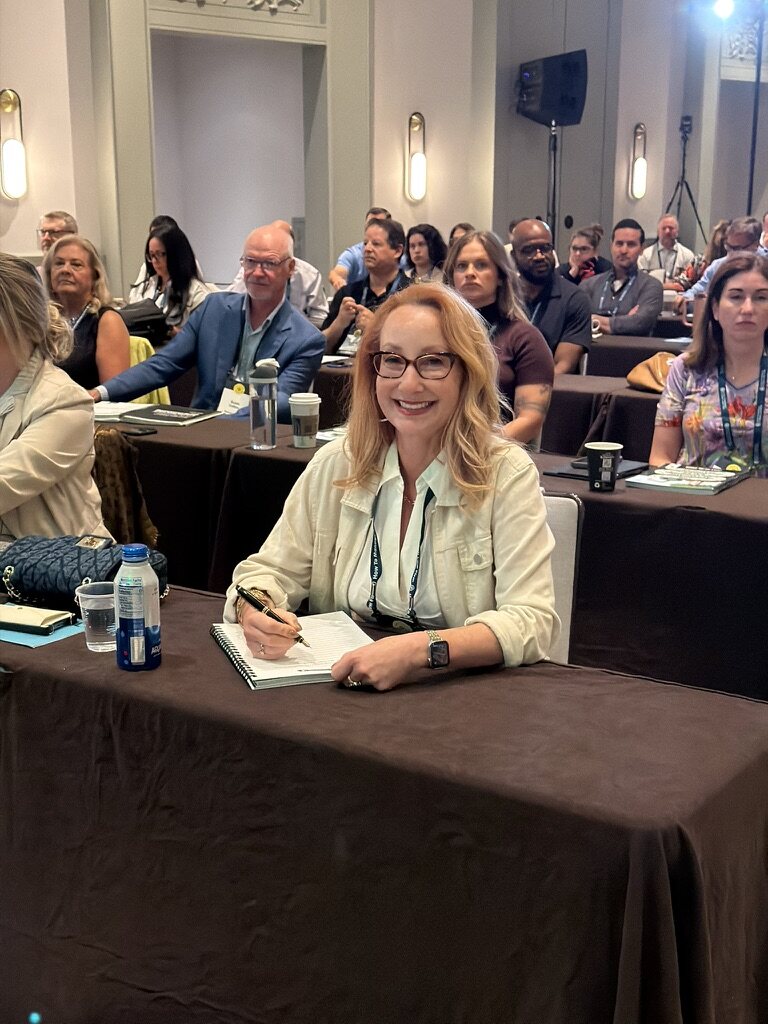 Smiling HTM member seated at a How To Manage A Small Law Firm event