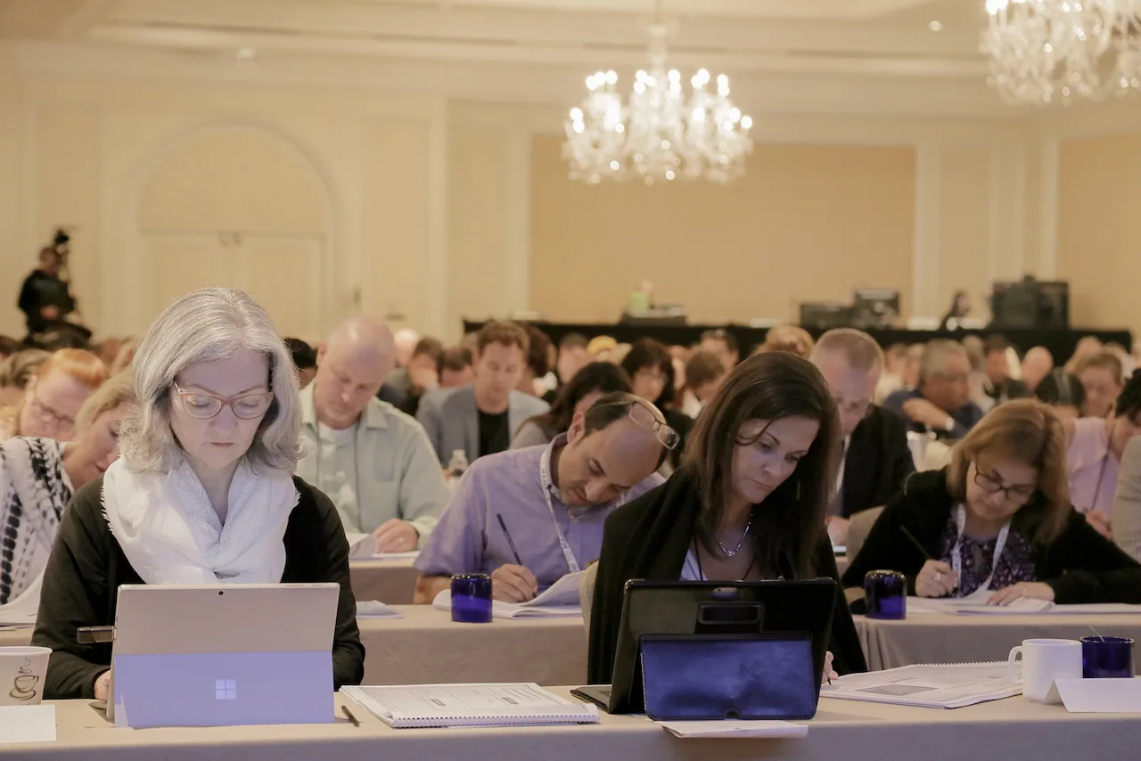 Law firm owners working through planning materials during an HTM workshop.