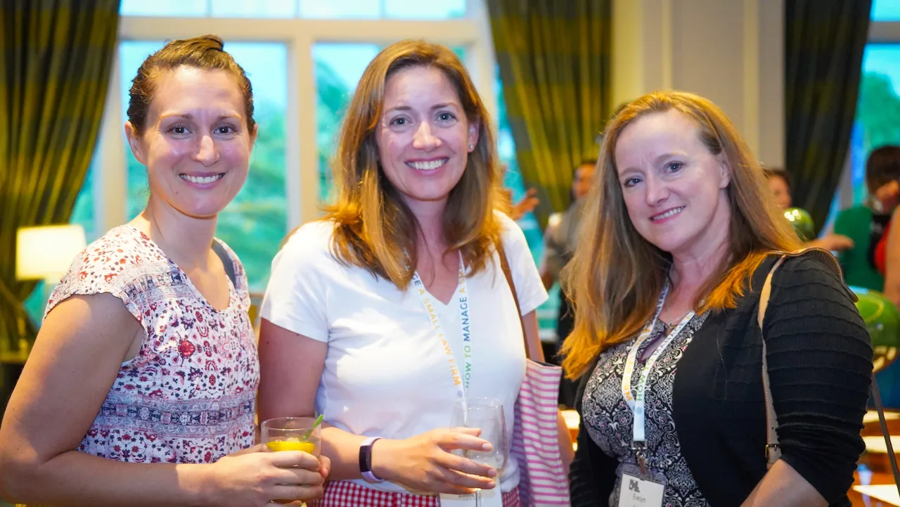 Three law firm owners enjoying a conversation at an HTM gathering.