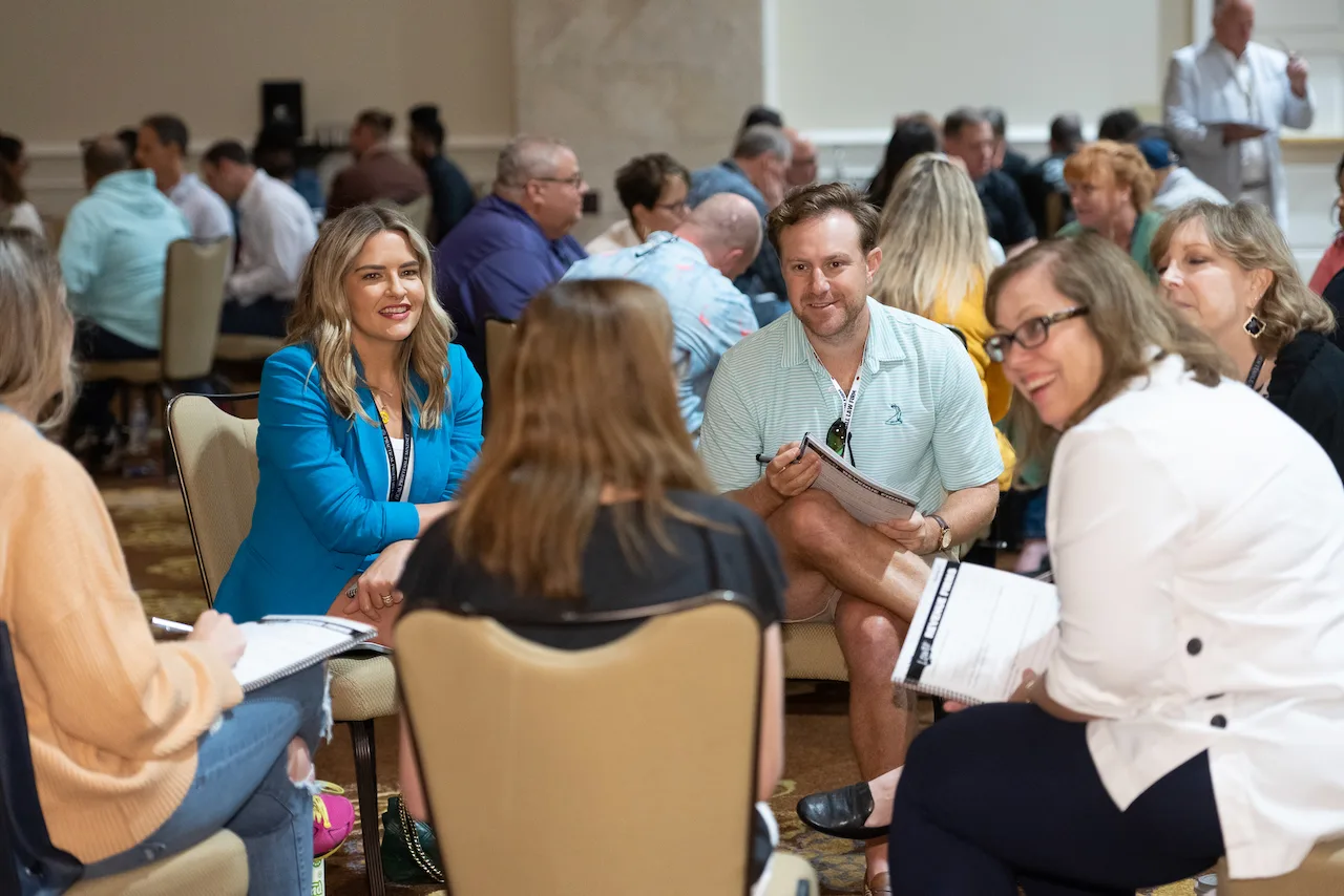 A small group of law firm owners working through ideas around a table.
