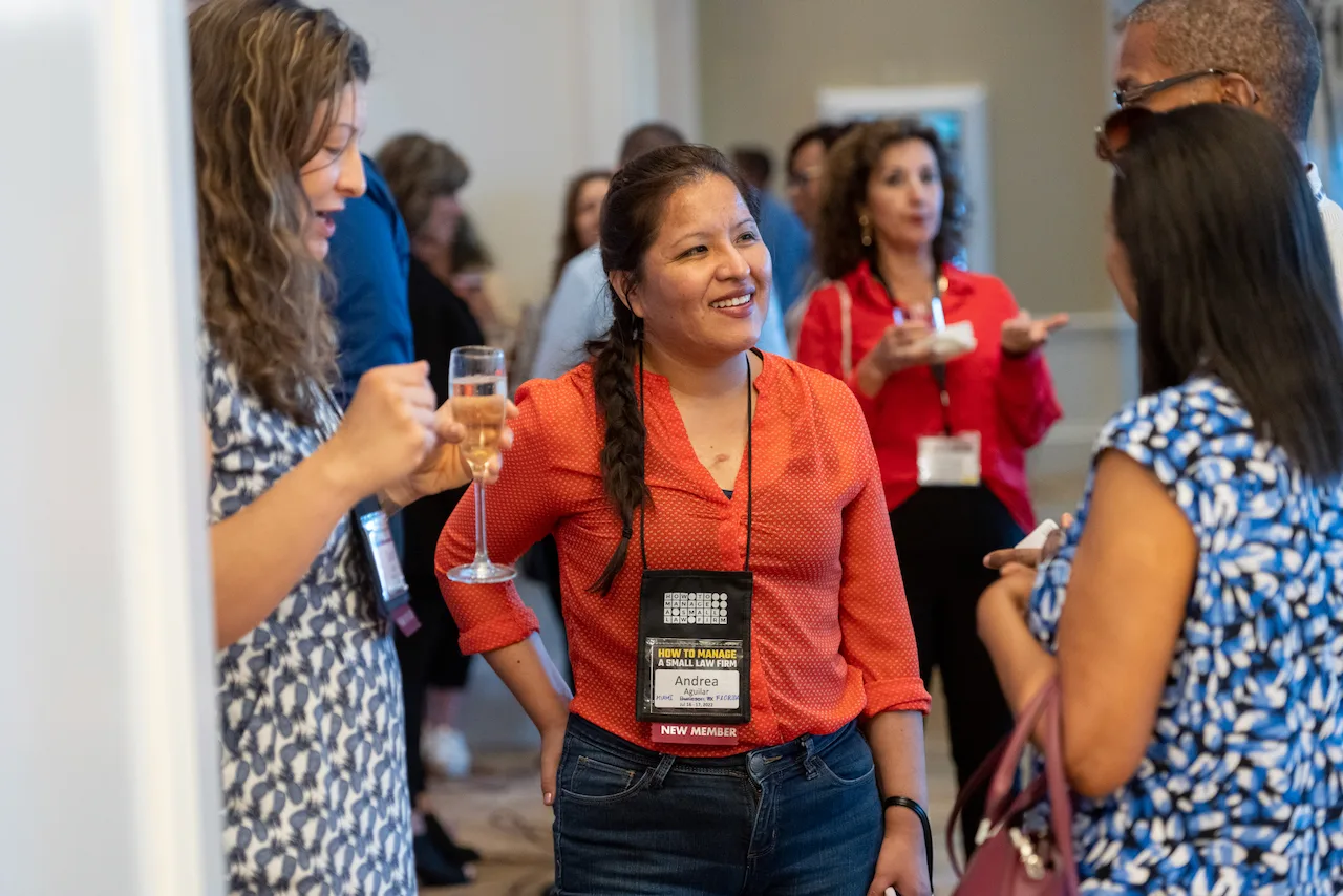 HTM members connecting during a busy networking session.